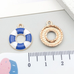 Detail of blue and white lifebuoy charm with gold metal backing for DIY jewelry
