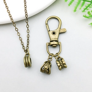 Close-up of antique bronze alloy butterfly pendant and lobster clasp jewelry set