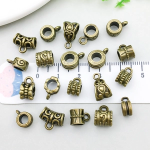 Antique bronze alloy bail beads spacers for DIY jewelry with ruler for scale