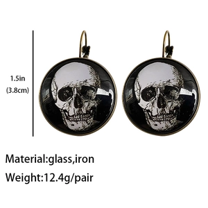 Detail view of vintage skull earrings with glass cabochon and size specifications