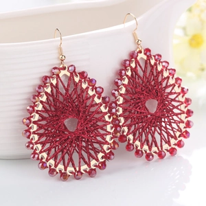 Handmade red thread wrapped teardrop earrings with crystal beads on a gold frame
