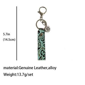 Détail du porte-clés en cuir vintage turquoise avec pendentif tournesol et anneau en alliage