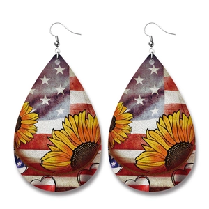 Close-up of teardrop leather earrings with American flag and sunflower pattern