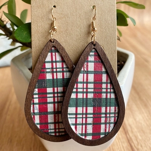 Detail of teardrop wooden earrings with red and green plaid inlay on a display card