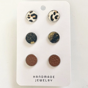 Three-pair set of round leather and leopard print horsehair stud earrings on display card