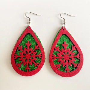 Close-up of teardrop Christmas earrings with red felt snowflake and green glitter layer
