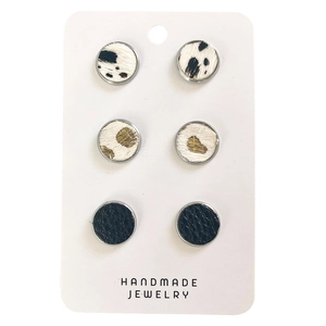 Three pairs of vintage round leather and faux fur stud earrings on display card