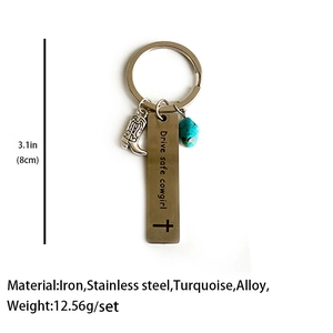 Detail of Western keychain with cowgirl boot pendant, turquoise stone and metal quote tag
