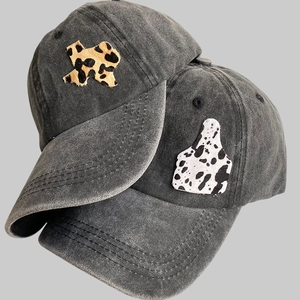 Vintage washed charcoal baseball cap featuring leopard Texas map and cow print ear tag patch