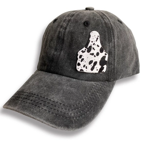 Faded grey denim baseball cap with cow print cow tag patch on white background