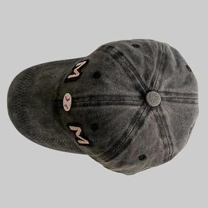 Detail of Baseball Mom embroidery on washed dark grey cotton denim vintage sports cap