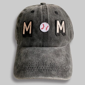 Detail of MOM embroidery with baseball icon on washed charcoal denim sports cap