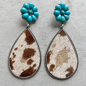 Detail of Western turquoise flower earrings with animal print leather teardrop pendants
