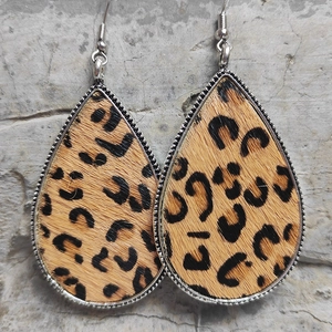 Detailed view of teardrop leopard print horsehair earrings with silver beaded metal edges
