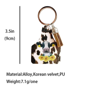 Cow print ear tag keychain with sunflower and cow head motif with leather tassel