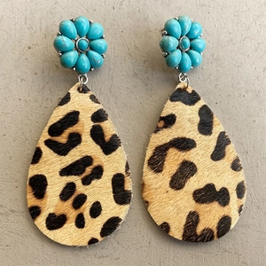 Detail of leopard print teardrop earrings with turquoise flower studs and fur texture