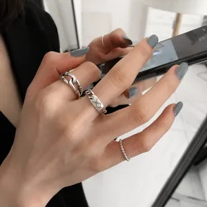 Three-piece minimalist silver ring set with chain and geometric engraving design
