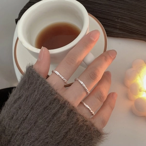 Three-piece set of S925 silver irregular textured twig rings for women in lifestyle setting