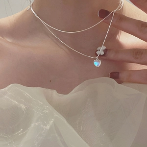 Double-layered S925 silver heart necklace featuring a blue moonstone pendant on the model