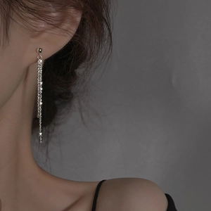 Orecchini a nappa in argento con cristalli scintillanti indossati da una modella