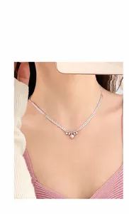 Detail of silver heart charm chain ring with adjustable pull slider on female finger