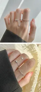 Detail of silver heart charm chain rings set with minimalist link design for women