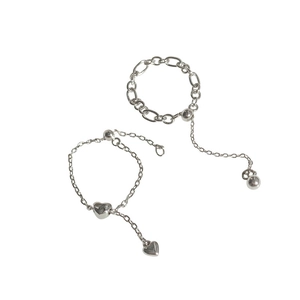 Silver heart pendant chain rings with adjustable tassel design on white background