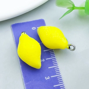 Detail of yellow lemon charms on a purple ruler showing approximately 2cm size