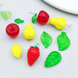 Detailed view of mixed acrylic fruit charms including strawberry and lemon for DIY jewelry