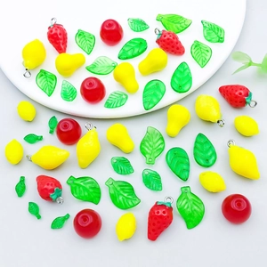 Detailed close-up of mixed acrylic fruit charms including strawberry and lemon for DIY jewelry