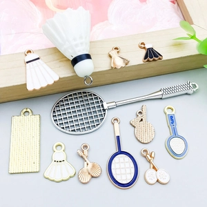 Detailed close-up of mixed white enamel badminton and racket pendants for DIY jewelry