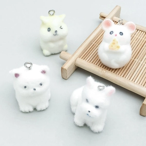 Macro shot of fluffy flocking animal pendants with silver hooks for jewelry making