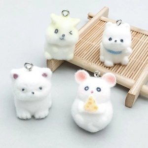 Detail of colorful flocked animal charms featuring cute cats and mouse with metal rings