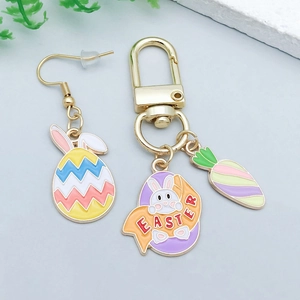 Detail of colorful enamel Easter bunny and egg charms with gold finish and Easter text