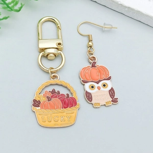 Detailed enamel harvest basket keychain with lucky lettering and cute owl earring charms