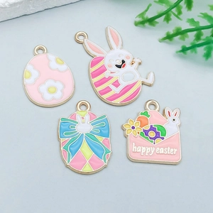 Detail of colorful enamel Easter charms featuring rabbit and egg designs in gold alloy