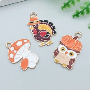 Detail of colorful Thanksgiving charms featuring turkey, mushroom and owl for DIY jewelry