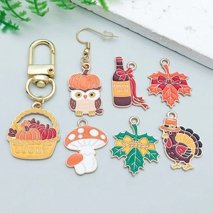 Detail of colorful Thanksgiving enamel charms with turkey and maple leaf designs
