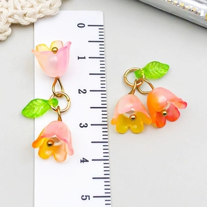 Detailed macro view of 3cm colorful acrylic lily of the valley flower pendant with ruler