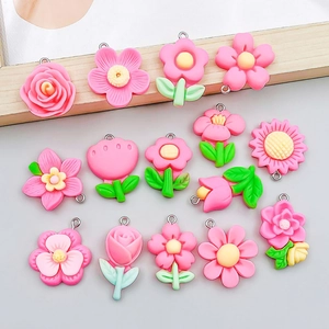Detailed view of pink resin flower pendants with metal loops for DIY jewelry making