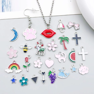 Macro shot of colorful enamel alloy charms with hearts, flowers and moon for DIY jewelry
