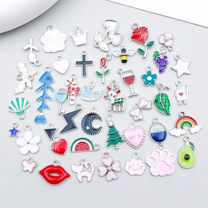 Detailed assortment of colorful enamel charms featuring flowers, animals and fruit shapes