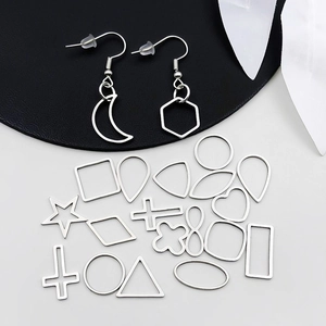 Macro shot of silver stainless steel geometric pendants and earring hooks for DIY jewelry