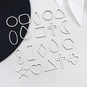 Detailed view of mixed silver stainless steel geometric hollow pendants for DIY jewelry