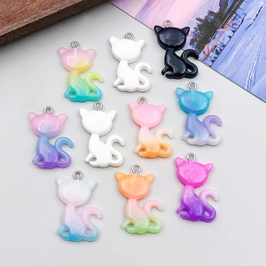 Detailed view of colorful resin cat charms with glitter and gradient finishes for DIY crafts
