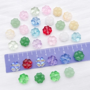 Mix of 30 colorful glass four-leaf clover beads for DIY jewelry making with a scale ruler