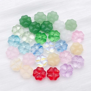Macro view of colorful glass clover-shaped spacer beads for DIY jewelry making