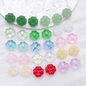 Close-up of colorful four-leaf clover glass spacer beads for DIY jewelry making