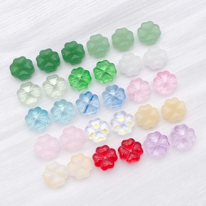 Macro shot of colorful glass clover spacers for DIY bracelet and necklace making