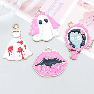 Macro detail of pink Halloween skull bride and ghost alloy enamel charms for DIY jewelry